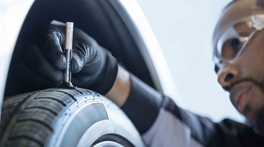 Technician performing wheel alignment